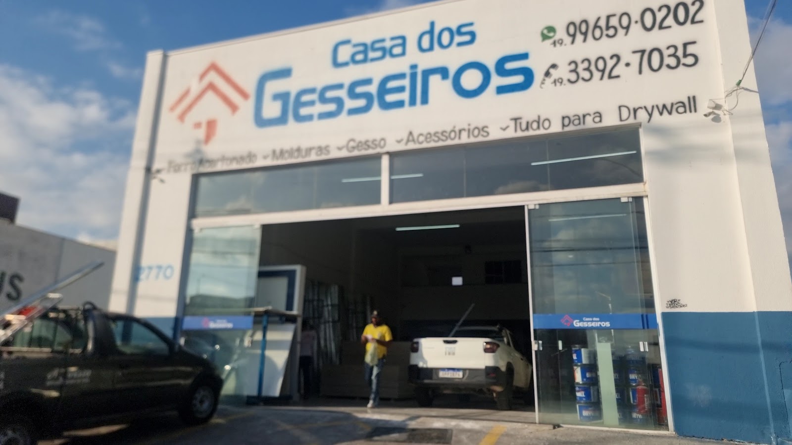 Entrada da Casa dos Gesseiros com o letreiro e os telefones (19) 99659-0202 e (19) 3392-7035 pintados na fachada
